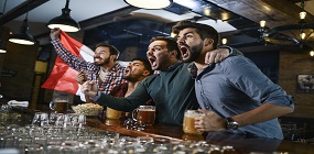 Excited fans drinking at a bar